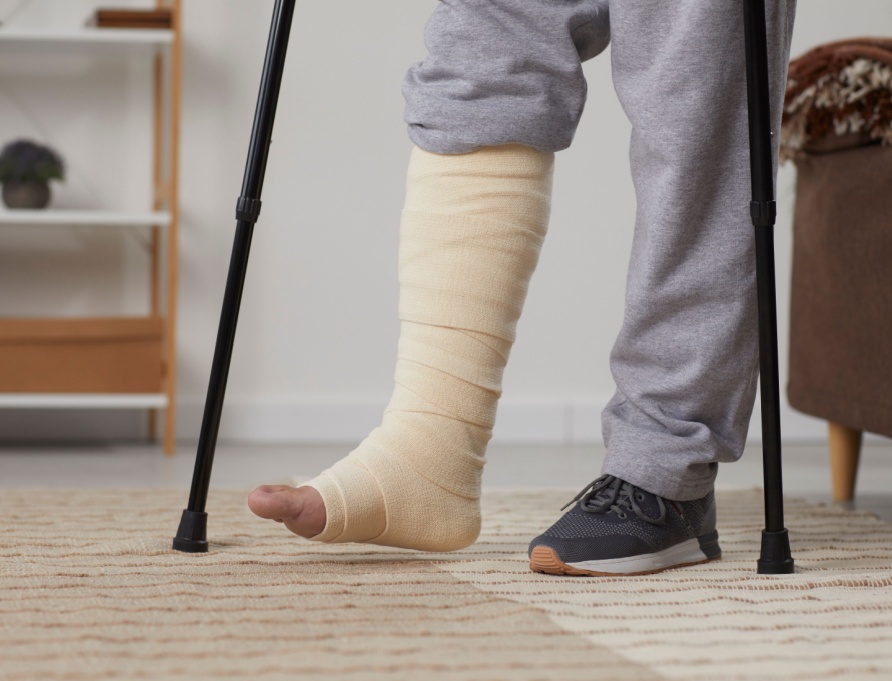 A man with a broken leg using crutches.