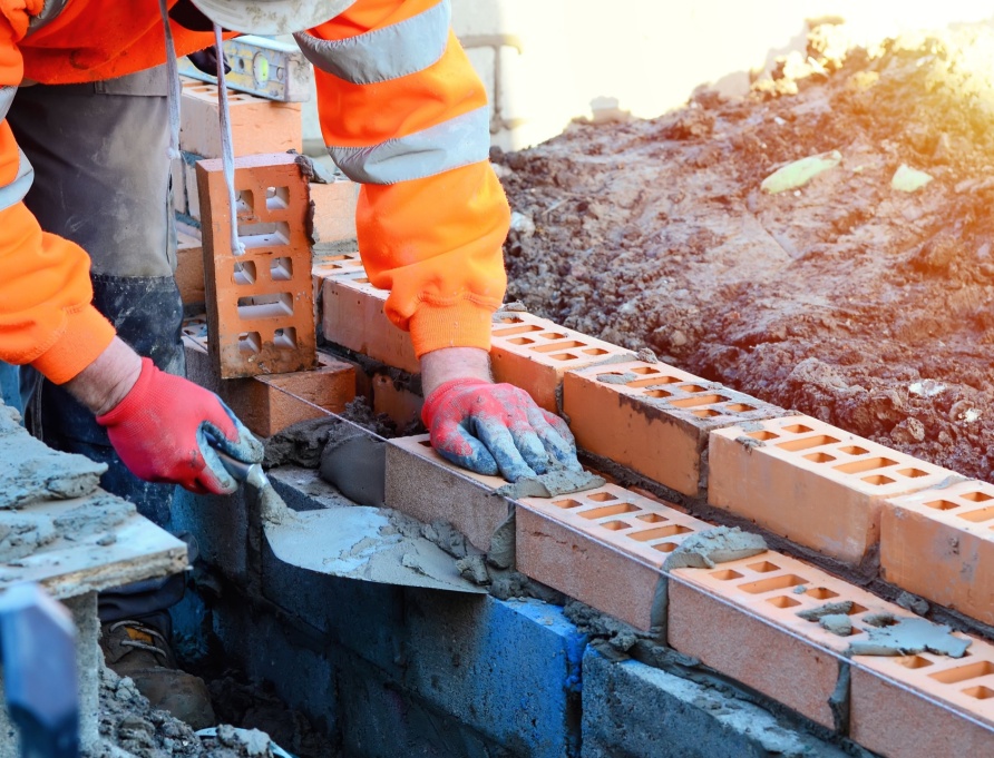 A bricklayer working on a construction site.