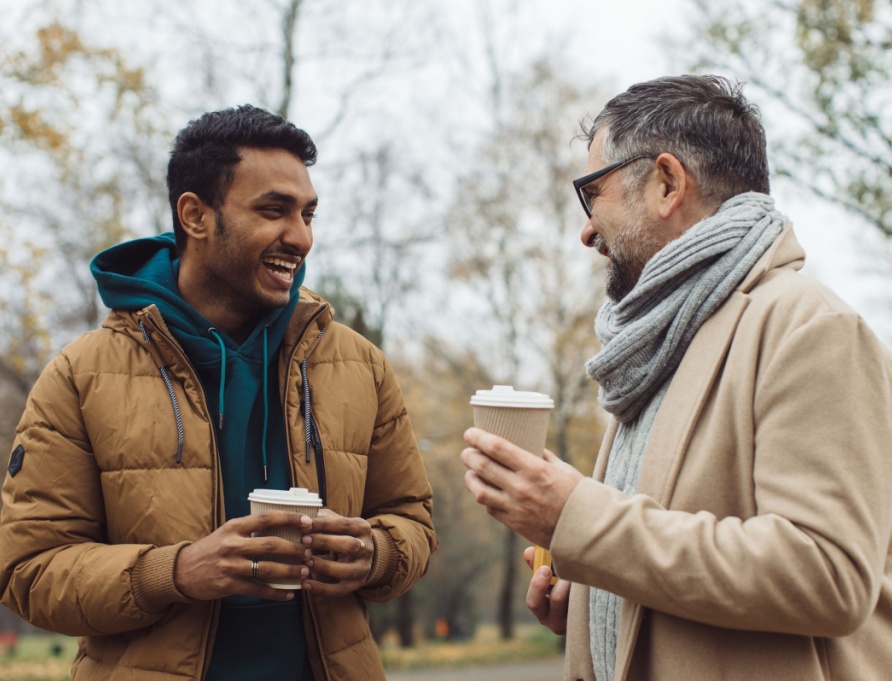 Two men talking together outdoors.