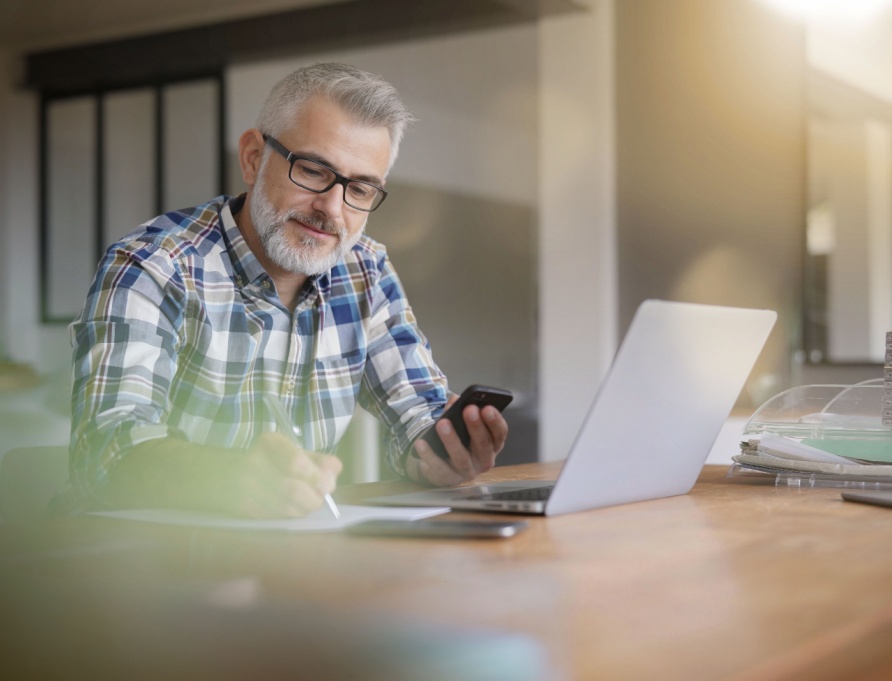 A man using a computer in a home office.