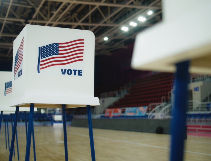 A voting booth with an American flag.