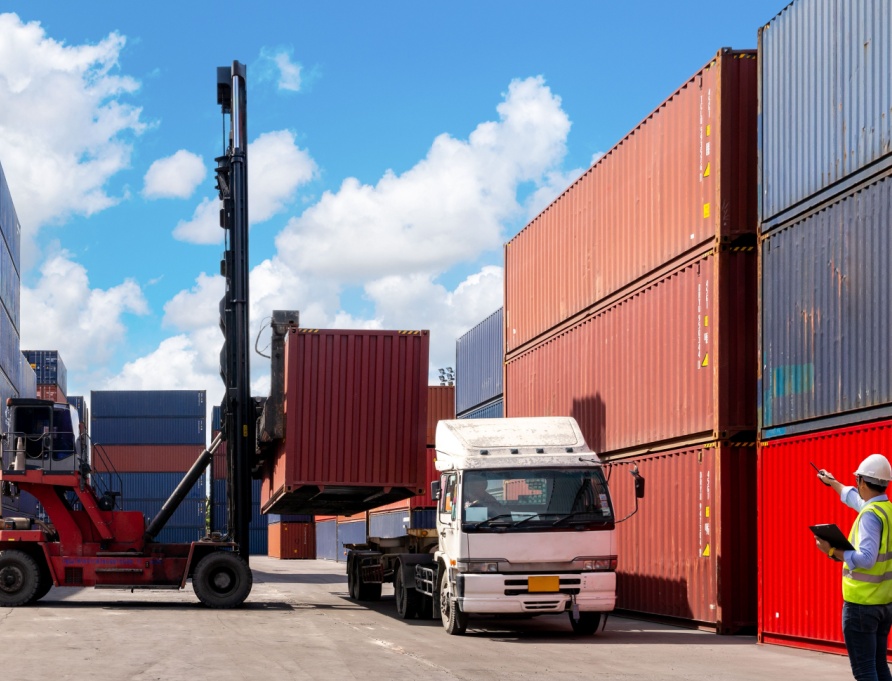 A foreman organising containers from a cargo ship.